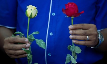 A man holds roses as he prays for the missing Malaysia Airlines Boeing 777-200 plane at a hotel in Putrajaya.