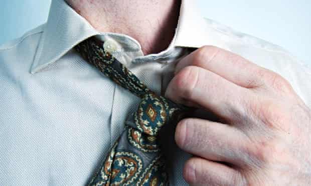 Stress at work: a man loosening his tie