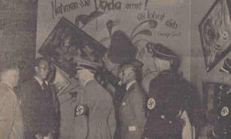 Adolf Hitler and other Nazi officials at the Dada wall at the Degenerate Art exhibition, July 16, 19