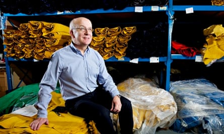 New Balance factory manager Andy Okolowicz sits on bales of fabric