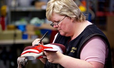 A woman works on a shoe at the New Balance factory in Flimby, Cumbria