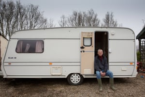 Retired Royal Engineer Philip Maye manoeuvres a caravan on his drive
