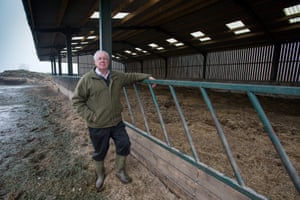 At Wisteria Farm, Bob Hall checks on his flood-damaged yard, thick with a foul-smelling sludge, and empty livestock sheds