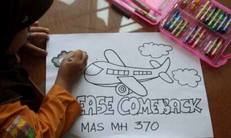 Eight-year-old Syira Nazia Hutabarat, from Medan in Indonesia,works on a picture praying for the Malaysia Airlines flight MH370 to return.