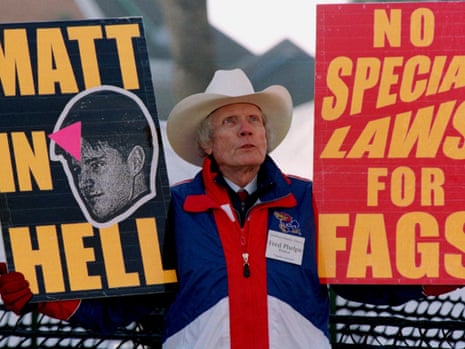 Pastor Fred Phelps Sr displays provocative placards in Laramie, Wyoming in April 1999