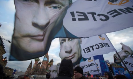 People rally in Red Square with banners and portraits of Vladimir Putin, reading "We are together.