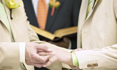 Man placing ring on another man's finger