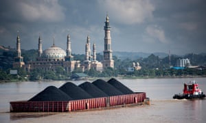 Coal barges come down the Mahakam river in Samarinda, East Kalimantan, Indonesian Borneo every few minutes. 