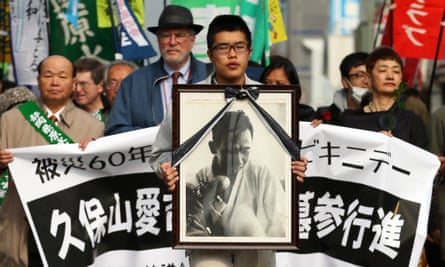 In Yaizu, Japan, a man holds a portrait of Aikichi Kuboyama at a march to mark the Bikini Atoll anniversary.
