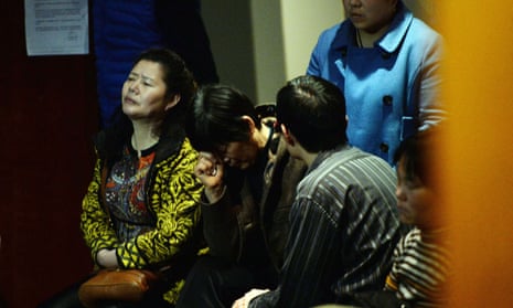 Chinese relatives of passengers from the missing Malaysia Airlines flight MH370 react as they wait for news at the Metro Park Lido Hotel in Beijing.