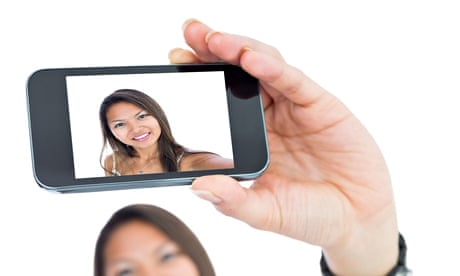 Smiling Asian woman taking a selfie