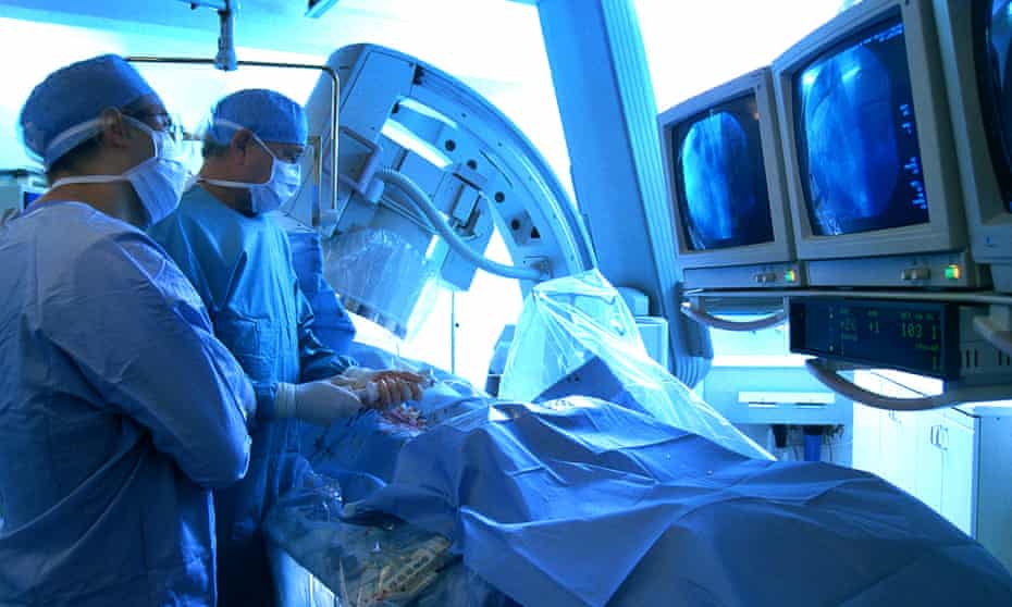 Surgeons operate on a patient's heart