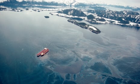 Staining the vista of the Chugach Mountains, the   Exxon Valdez lies atop Bligh Reef two days after the grounding