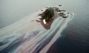 Original caption: Oil leaches off an island beach weeks after the Exxon Valdez lost its oil. Alaska, USA, 1989