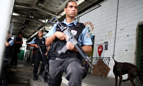 Military police officers keep watch in one of Rio's favelas.