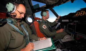 Co-Pilot Flying Officer Marc Smith (R) and a crewman calculate fuel consumption aboard a Royal Australian Air Force (RAAF) AP-3C Orion aircraft search for the missing Malaysian Airlines Flight MH370 over the southern Indian Ocean March 24, 2014.