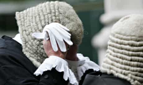 A Judge adjusts his wig