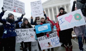 Demonstrators rally outside of the U.S. Supreme Court during oral arguments in Sebelius v. Hobby Lobby.