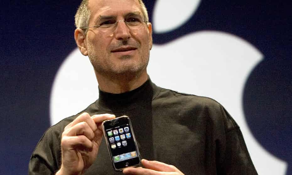 Steve Jobs holding the original iPhone at its introduction in January 2007: he had threatened to fire the engineers working on the original project.