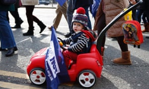 A child holds an NUT flag during a protest march in Liverpool.