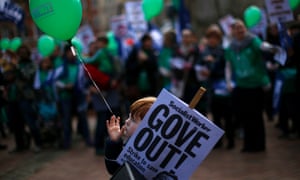 Ben Jackson clutches a placard during a National Union of Teachers march in Birmingham.