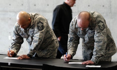 US air force personnel fill out applications at a job fair.