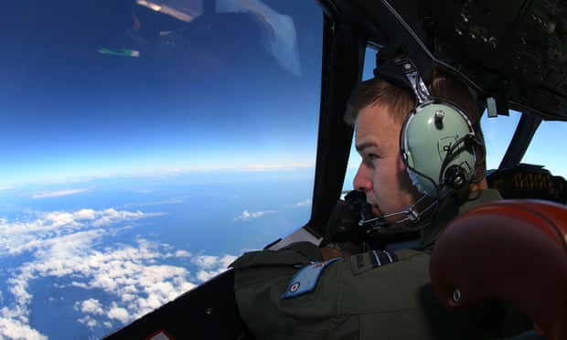 RAAF flight lieutenant Russell Adams looks out from the cockpit of an AP-3C Orion whilst on a MH370 search mission in the southern Indian Ocean