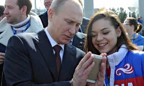 Vladimir Putin looks at a mobile