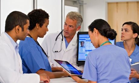 Doctors using computer together in hospital