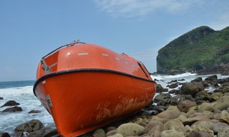 A lifeboat that washed up on central Java's Karangjambe Beach leaking after hitting coral and rocks.