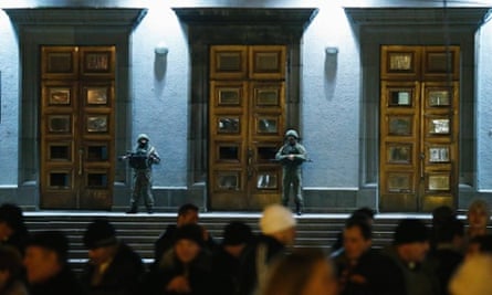 Armed men stand guard at the local government headquarters in Simferopol, Crimea in Ukraine.