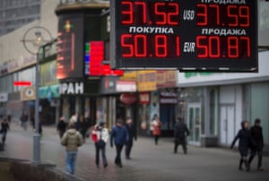 People walk past a currency exchange office in downtown Moscow, Russia, Monday, March 3, 2014.