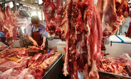 A butcher cuts up beef at a meat market in Beijing. With more money in their pockets, millions of Chinese are seeking a richer diet and switching to beef, driving imports to record levels