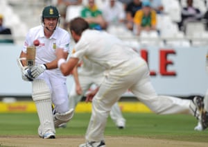 Australia's Ryan Harris, front, prevents South Africa's Graham Smith, from making a run during the third day of the third test in Cape Town.