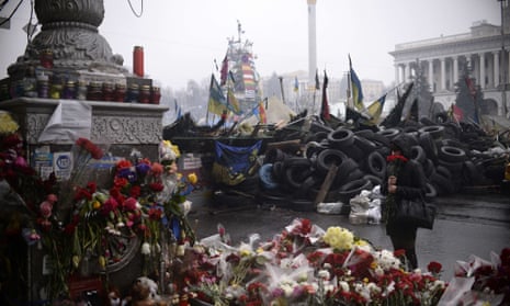 anti-government protestors and riot police at a barricade on Independence square in central Kiev on March 3, 2014.