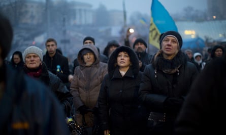 People listen to  a political speech on a stage in  Kiev's Independence Square on Monday, 3 March