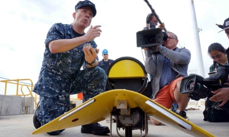 US navy director of ocean engineering captain Mark Matthews introduces equipments to be used for searching the missing Malaysia Airlines Flight MH370 in Perth on Sunday.