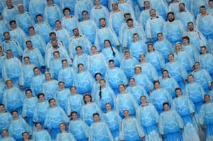 A choir sing, dressed all in blue.