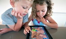 Children playing a computer game on an iPad tablet