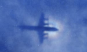 This shadow of a Royal New Zealand Air Force P3 Orion aircraft is seen on low cloud cover while it searches for missing Malaysia Airlines flight MH370, over the Indian Ocean.