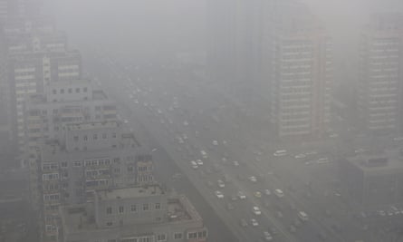 Cars drive on the Three Ring Road amid heavy haze in Beijing in February 2014