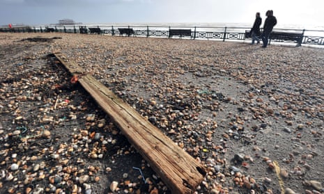 Driftwood and pebbles blown up from the beach litter Hove promenade in Brighton on the south coast of England due to high winds from a winter storm.