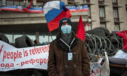 Pro-Russian protesters stand guard near the occupied regional administration building in Donetsk