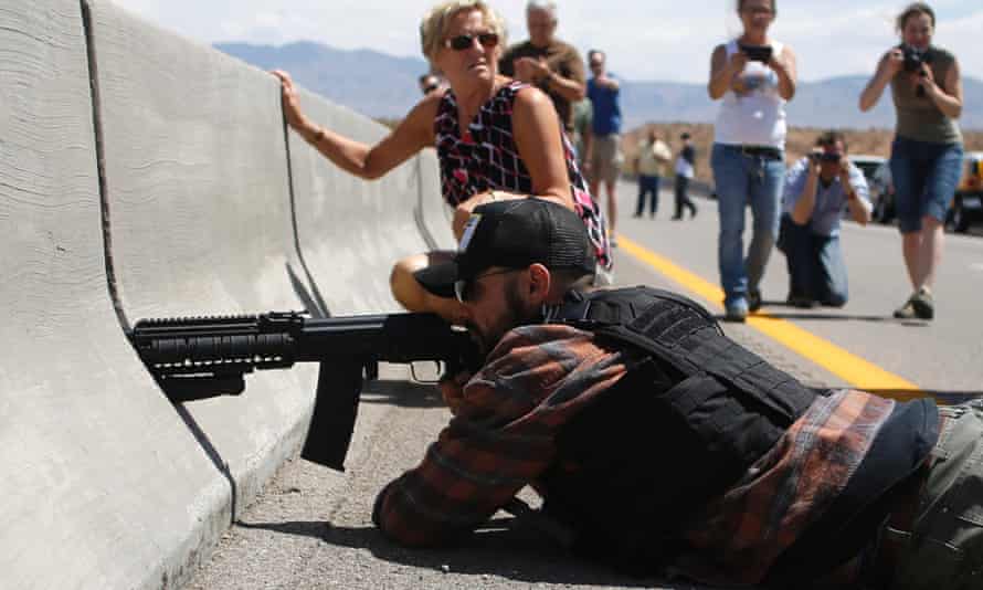 A protester aims his weapon from a bridge next to the Bureau of Land Management's base camp