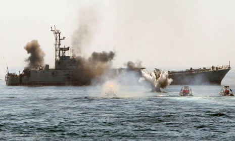 An Iranian warship and speed boats take part in a naval war game in the Persian Gulf.