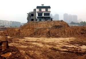 April 2013: Two nail houses left isolated on a construction site in Yichang, a city in central China's Hubei province