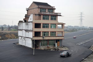 November 2012: Perhaps the most famous nail house - left in the middle of a newly built road in Wenling, Zhejiang province. An elderly couple refused to sign an agreement to allow their house to be demolished.