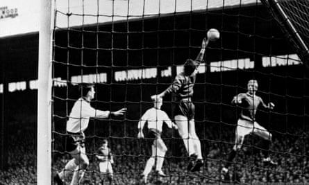 Manchester United's Denis LAw, in mid air, right, sees the ball just elude Liverpool goalkeeper Tommy Lawrence's fingers to go over the bar in the First Division match at Old Trafford, Manchester. Tommy Smith and Chris Lawler are watching. United won 3-0.