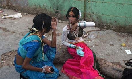 Indian transgender dancers put on makeup before a performance in Kolkata