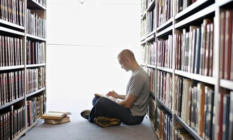 Man Reading Book in Library